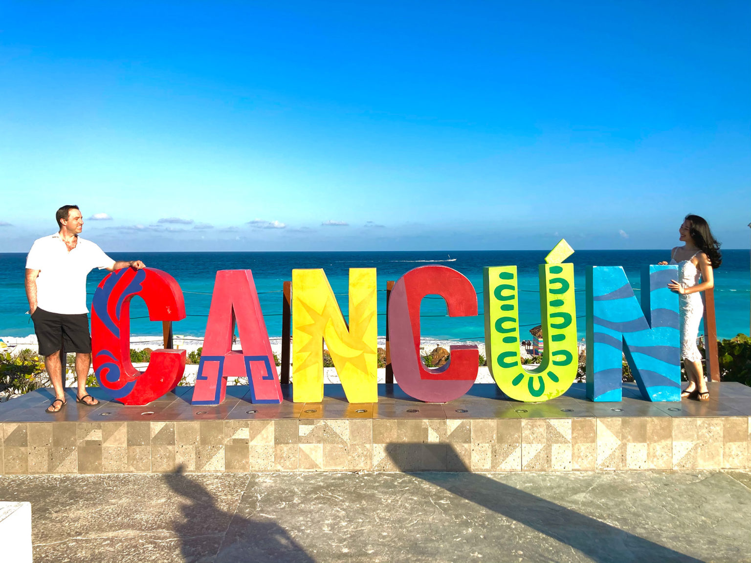Ethan and Kie by the Cancun sign